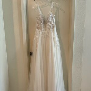 Lillian West: A-Line Bridal Dress with Plunging Bikini Neckline and 3D Flowers